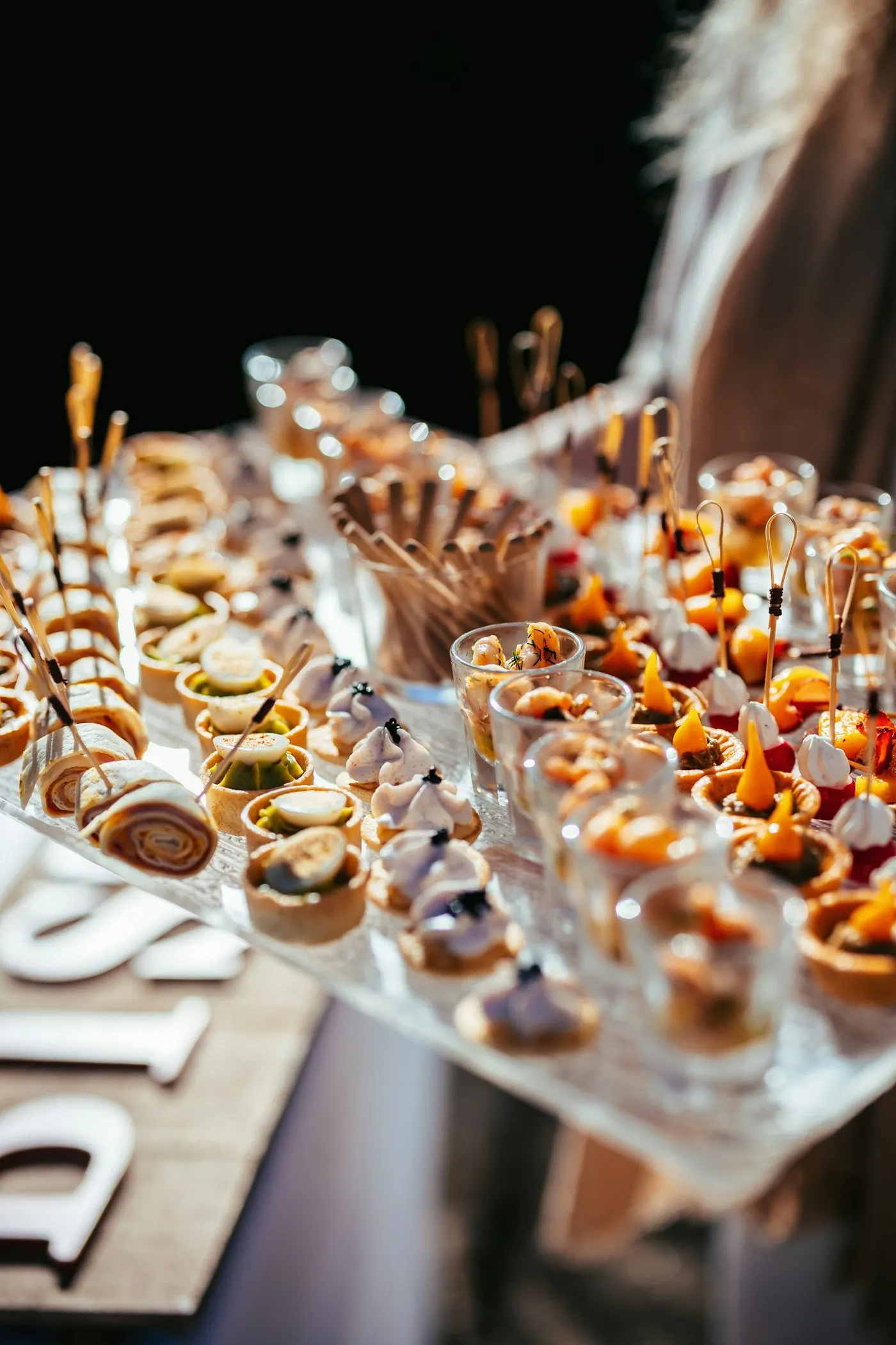 Dessert table of mini pastries and shot-glass desserts